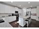 Modern kitchen with white cabinets, granite countertops, and large island at 2532 Ozella Sw Pl, Atlanta, GA 30331