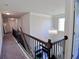 Upstairs hallway with chandelier and railing at 2532 Ozella Sw Pl, Atlanta, GA 30331