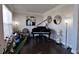 Music room with grand piano, hardwood floors, and large windows at 2532 Ozella Sw Pl, Atlanta, GA 30331