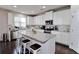 Modern kitchen with white cabinets, granite countertops, and large island at 2532 Ozella Sw Pl, Atlanta, GA 30331