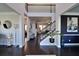 Two-story foyer with dark hardwood floors, a staircase, and artwork at 2532 Ozella Sw Pl, Atlanta, GA 30331