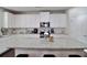 Modern kitchen with white cabinets, granite countertops, and large island at 2532 Ozella Sw Pl, Atlanta, GA 30331