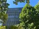 Brick building with many windows, surrounded by lush green trees at 3060 Pharr Court North Nw # 609, Atlanta, GA 30305