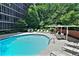 Inviting community pool with surrounding lounge chairs and patio tables at 3060 Pharr Court North Nw # 609, Atlanta, GA 30305