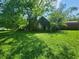 Overgrown outbuilding in a grassy yard at 688 Main St, Whitesburg, GA 30185