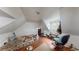 Small attic bedroom with sloped ceilings and window at 688 Main St, Whitesburg, GA 30185