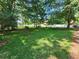 Large grassy front yard with mature trees at 688 Main St, Whitesburg, GA 30185
