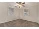 Bright bedroom with neutral walls and carpet, ceiling fan, and two windows with blinds at 2576 Godfrey Nw Dr, Atlanta, GA 30318
