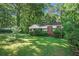Brick ranch house with a large yard and mature trees at 2576 Godfrey Nw Dr, Atlanta, GA 30318