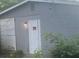 Gray brick house with a white door and boarded-up windows at 366 Hamilton E Holmes Nw Dr, Atlanta, GA 30318