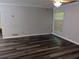 Living room with dark wood-look floors and a window at 2936 Parc Lorraine # 2936, Lithonia, GA 30038