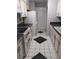 Galley kitchen with white cabinets, black countertops, and tile floor at 2936 Parc Lorraine # 2936, Lithonia, GA 30038