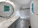 Updated bathroom features a gray vanity, marble countertop, and tile shower at 4318 Christine Ct, Decatur, GA 30035