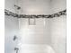 White tiled shower with black and gray accent tile at 4318 Christine Ct, Decatur, GA 30035