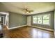 Spacious living room featuring hardwood floors, gray walls, and a ceiling fan at 4010 Princeton Sw Pl, Atlanta, GA 30331