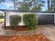 Detached garage with black door and manicured shrubs at 51 Holt Ne Rd, Marietta, GA 30068