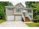 Two-story house with two-car garage, wooden stairs and green shutters at 3364 Joseph Nw Dr, Acworth, GA 30101