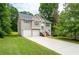 Tan two-story house with two-car garage and wooden stairs at 3364 Joseph Nw Dr, Acworth, GA 30101