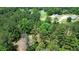 Aerial view of property showing wooded lot near church at 2576 E Paulding Dr, Dallas, GA 30157