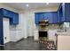 Updated kitchen featuring blue cabinets, stainless steel appliances, and granite countertops at 301 Ashbourne Trl, Lawrenceville, GA 30043