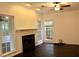 Living room with fireplace, dark wood floors, and abundant natural light at 301 Ashbourne Trl, Lawrenceville, GA 30043