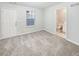 Spacious bedroom with plush carpeting, an adjoining bathroom, and ample natural light at 6756 Blackstone Pl # 6, Mableton, GA 30126