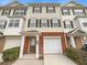 Beige three-story townhome with brick base and attached garage at 6756 Blackstone Pl # 6, Mableton, GA 30126