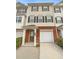 Beige three-story townhome with brick base and attached garage at 6756 Blackstone Pl # 6, Mableton, GA 30126