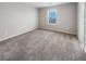 Spacious carpeted bedroom with large window at 6756 Blackstone Pl # 6, Mableton, GA 30126