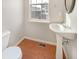 Small bathroom with pedestal sink and wood-look floor at 6756 Blackstone Pl # 6, Mableton, GA 30126