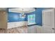 Formal dining area with blue walls, white trim, and a unique light fixture at 3203 Puritan Way, Mcdonough, GA 30252