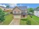Two-story brick home with attached garage and landscaped yard at 3203 Puritan Way, Mcdonough, GA 30252