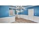 Bright dining room with blue walls, white wainscoting, and a statement chandelier at 3203 Puritan Way, Mcdonough, GA 30252