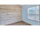 Bedroom with light blue walls, wood-look floors, and accent wall at 3203 Puritan Way, Mcdonough, GA 30252