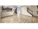 Spacious living area with kitchen and staircase views, featuring LVP flooring at 3203 Puritan Way, Mcdonough, GA 30252