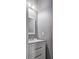 Small bathroom with gray walls, white vanity, and a rectangular mirror at 3203 Puritan Way, Mcdonough, GA 30252