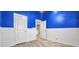 Blue and white bedroom with wood-look floors and two entrances at 3203 Puritan Way, Mcdonough, GA 30252