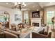 Spacious living area with a fireplace, large windows, and comfortable seating at 9170 Selborne Ln, Chattahoochee Hills, GA 30268
