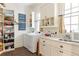 Bright laundry room with washer, dryer, and ample storage space at 9170 Selborne Ln, Chattahoochee Hills, GA 30268