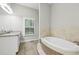 Primary bathroom with soaking tub and double vanity at 3483 Conley St, College Park, GA 30337