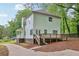 Two-story house with light green siding, deck, and driveway at 3483 Conley St, College Park, GA 30337