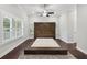 Spacious bedroom with dark wood platform bed and ceiling fan at 3483 Conley St, College Park, GA 30337