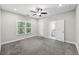 Bright and airy bedroom with carpet, ceiling fan, and en-suite bathroom at 3483 Conley St, College Park, GA 30337