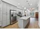 Modern kitchen features stainless steel appliances and a large island with granite countertops at 3483 Conley St, College Park, GA 30337