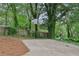 Outdoor basketball court nestled in a wooded backyard at 3483 Conley St, College Park, GA 30337