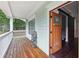 Front porch with wooden flooring and white railing at 3483 Conley St, College Park, GA 30337