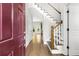 Bright entryway with hardwood floors, burgundy door and staircase at 1400 Village Creek Se Cir # 12A, Atlanta, GA 30316