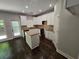 Modern kitchen with white cabinets, granite countertops, and dark hardwood floors at 1400 Village Creek Se Cir # 12A, Atlanta, GA 30316