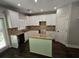 Kitchen boasts white cabinets, granite countertops, and an island at 1400 Village Creek Se Cir # 12A, Atlanta, GA 30316