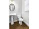 Powder room with pedestal sink, toilet, and dark hardwood floors at 1400 Village Creek Se Cir # 12A, Atlanta, GA 30316